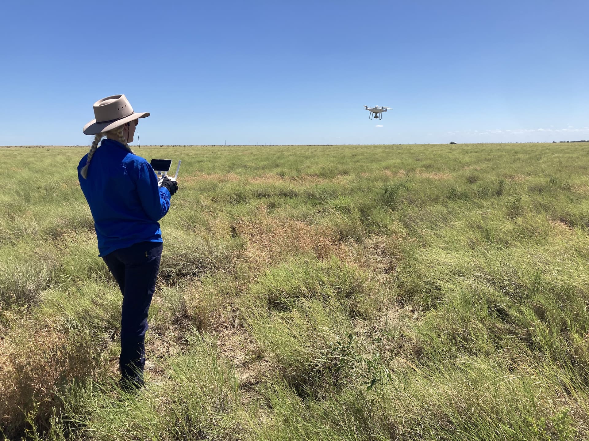 Lucy Gardner in the field with a drone. 
